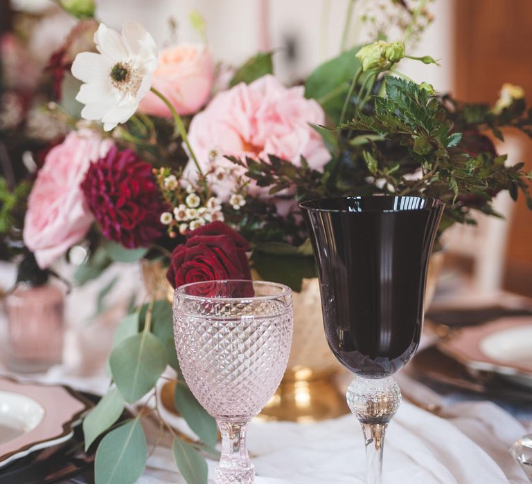 Ornate pink and black glass goblets for dramatic Pomegranate Noir wedding inspiration 