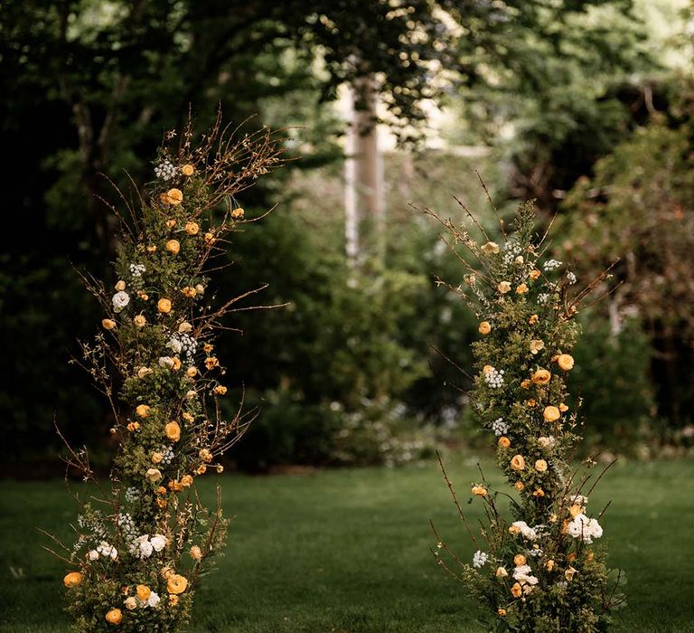 Vertical yellow flower and green floral arrangement 