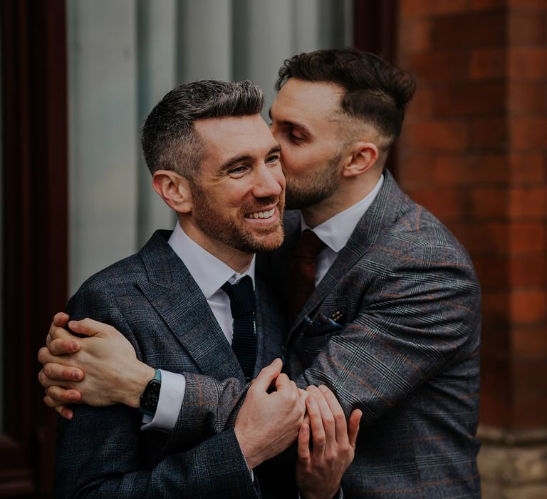 Groom kisses groom on the cheek for last minute wedding in London