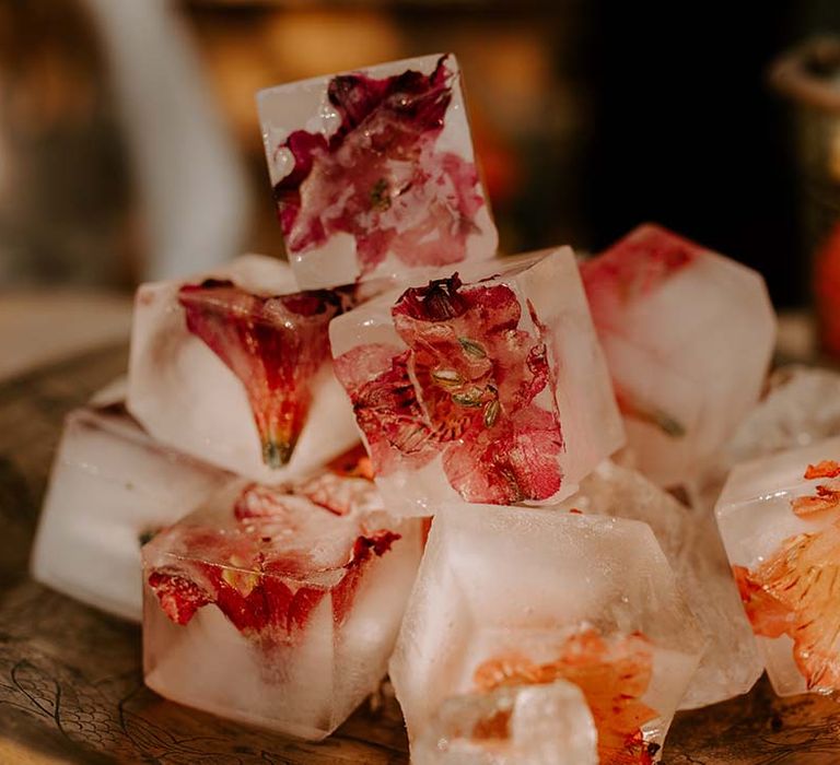 Ice cubes filled with edible flowers for wedding bar 