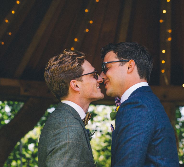 Grooms kiss on their wedding day for outdoor ceremony | Story + Colour