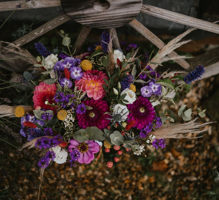 Pink, purple and green wedding bouquet with dried grass at late summer wedding in Norfolk