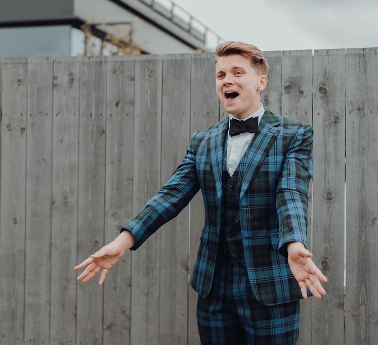 Groom wearing tartan suit sees his groom for the first time in first-look moment outdoors | Kim Williams Weddings