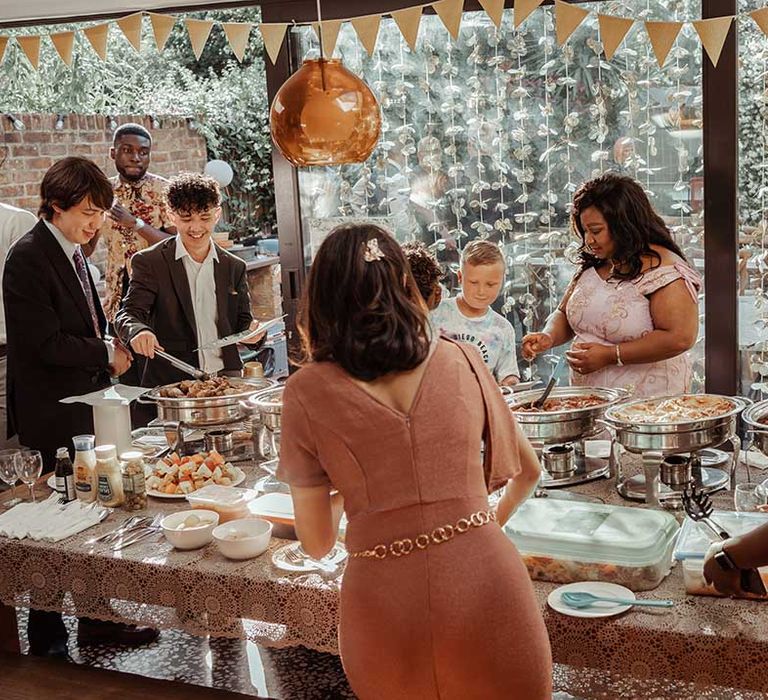 Wedding guests grab dinner for wedding reception