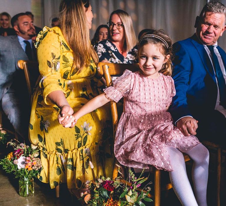 Wedding guests during ceremony at industrial venue in London