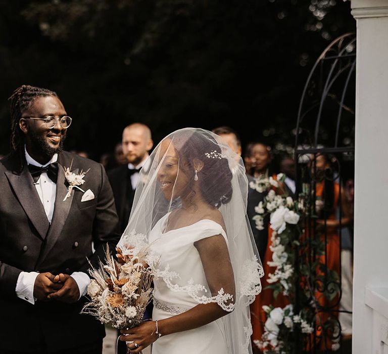 Grooms looks lovingly at his bride on their wedding day