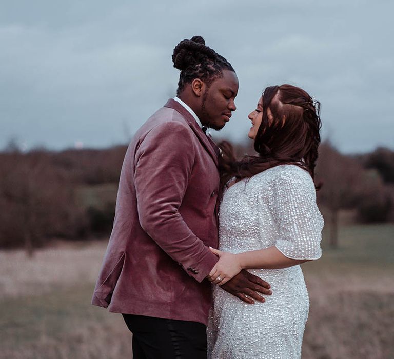 Groom wraps his arms around bride on their wedding day