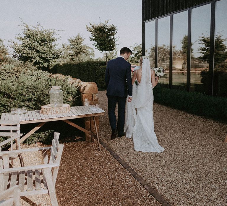 Bride and groom at the contemporary barn wedding venue next to welcome wedding sign 