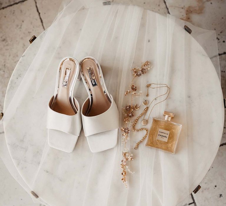 Bride's veil, gold jewellery, Chanel perfume and satin white mules