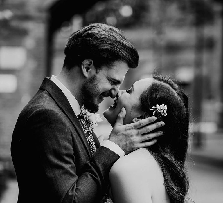 Bride and groom smiling at each other on their wedding day at The Castlefield Rooms in Manchester city centre