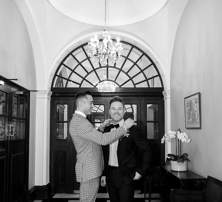 Grooms stand in Chelsea Old Town Hall on their wedding day