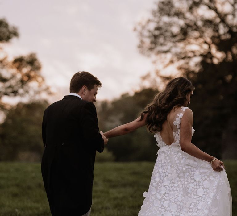 Bride in floral applique wedding dress from Mira Zwillinger 