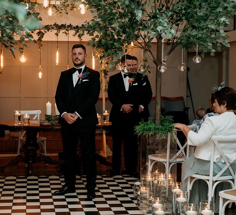 Groom stands waiting for the bride at Larkspur Lodge wedding venue 