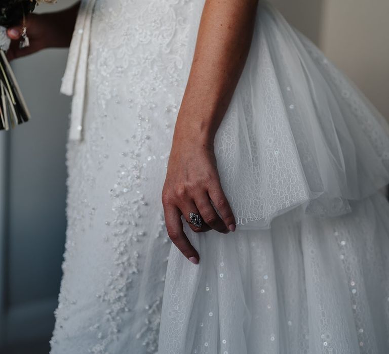 Bride wears Eva Lendal wedding dress with detachable skirt and sequinned embellishment 