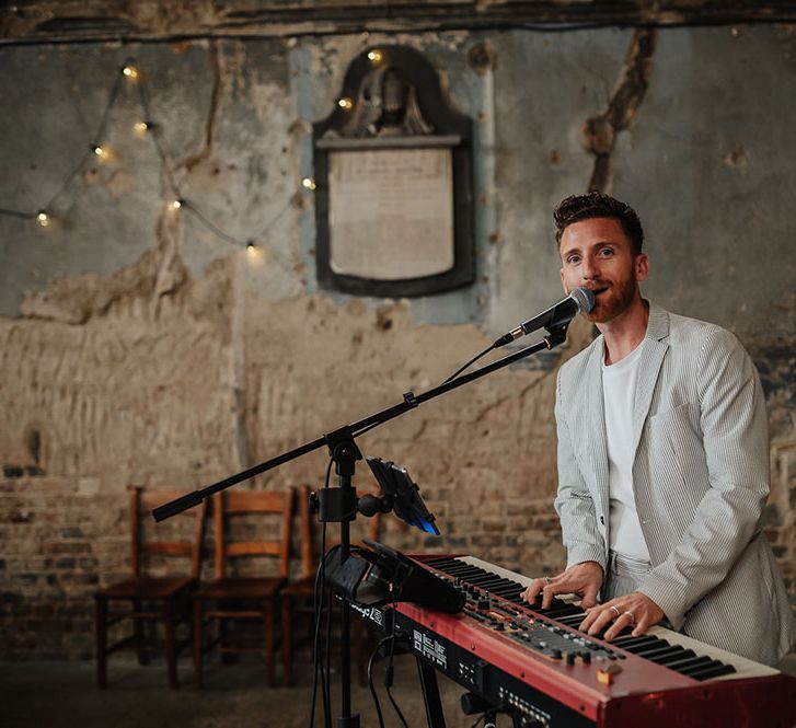 Wedding singer plays the piano at The Asylum during wedding ceremony 