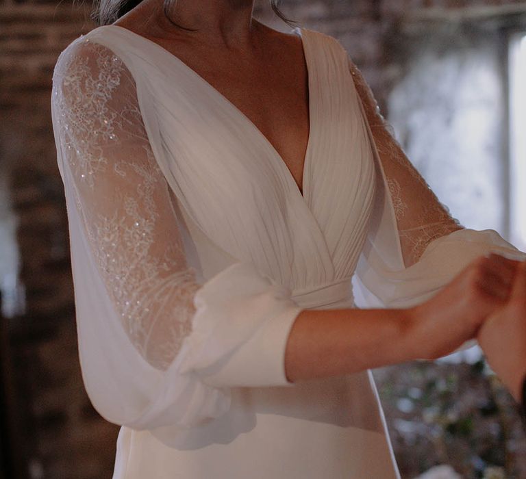 Bride wearing a sheer long sleeve wedding dress with sequins for a winter wedding 