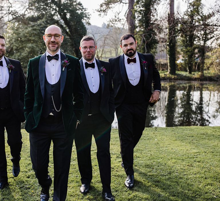 Groomsmen in traditional and classic black tie with the groom in a velvet tuxedo for the wedding at Brinsop Court Manor House and Barn