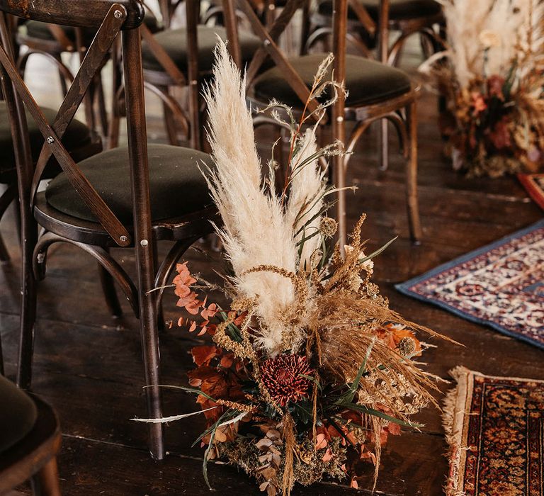 Dried floral arrangements with pampas grass line aisle at The Dreys wedding venue 