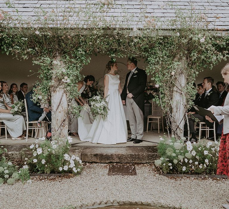 White wedding flowers decorate the outdoor area at the Devon hotel wedding venue 