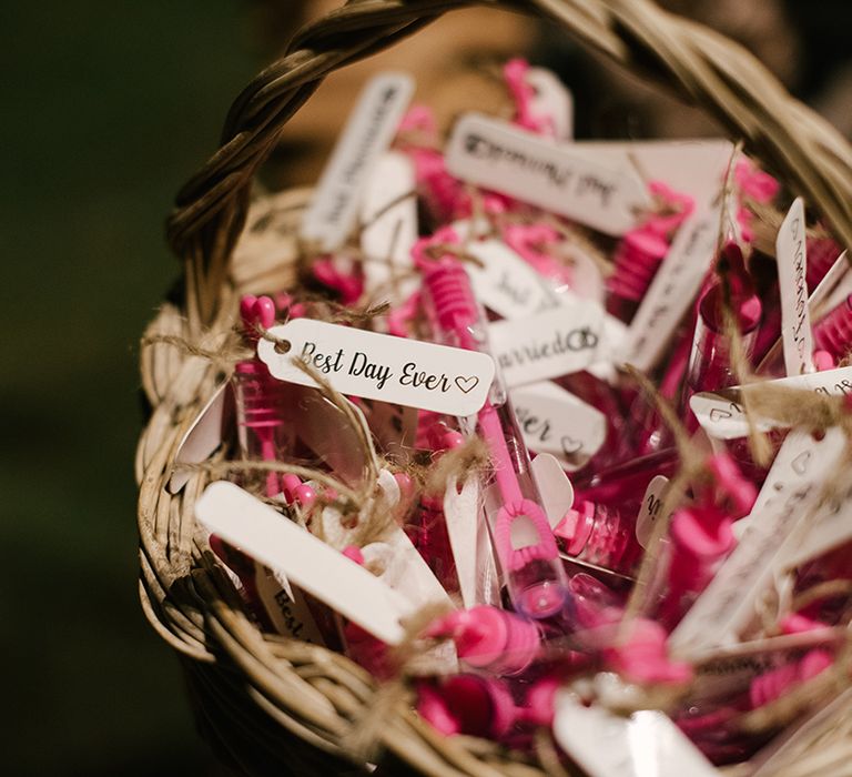 pink bubble wedding favours with best day ever tags in a basket