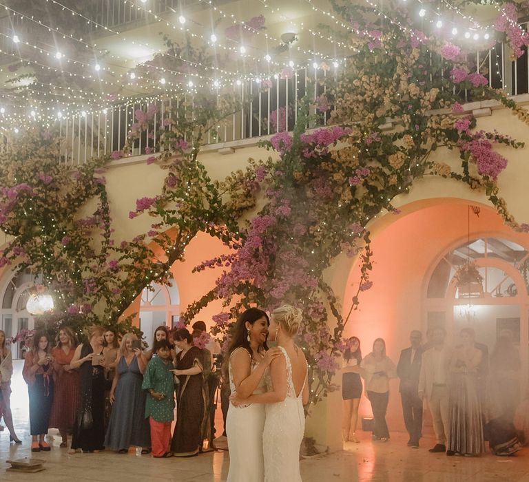 two brides in fitted wedding dress performing their first dance at their Croatia wedding 