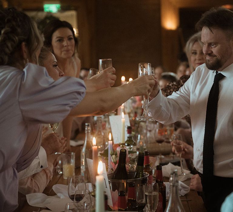 Wedding guests make a toast together at the wedding breakfast 