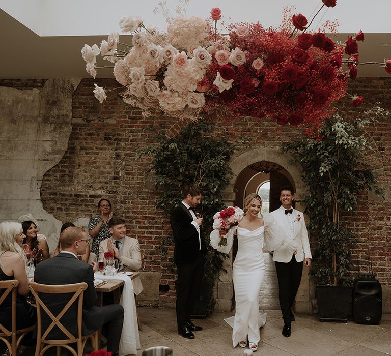 The bride and groom enter their wedding reception 