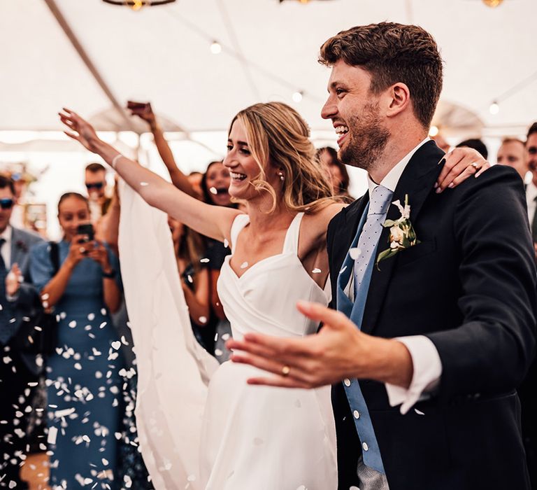 bride and groom entering the dance floor at their marquee Sennen Cove wedding 