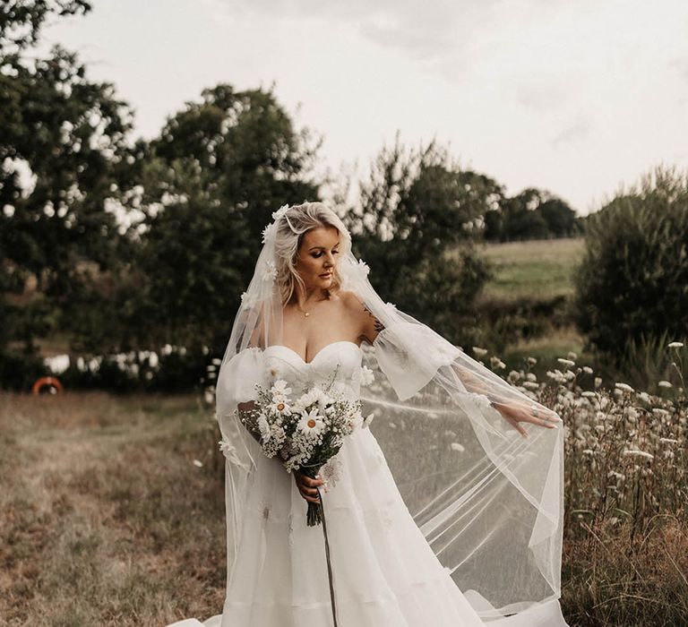 Bride wearing 3D daisy veil in sweetheart off the shoulder wedding dress at disco wedding 