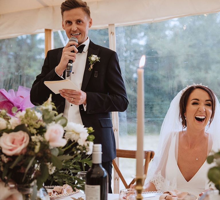 Groom speech at marquee wedding read out as the bride laughs 