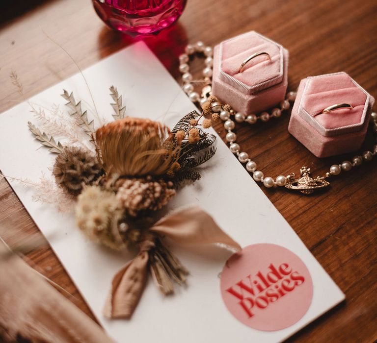 Pink velvet ring box and perfume bottle with wedding stationery 