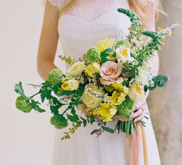 Yellow wedding bouquet with roses and foliage 