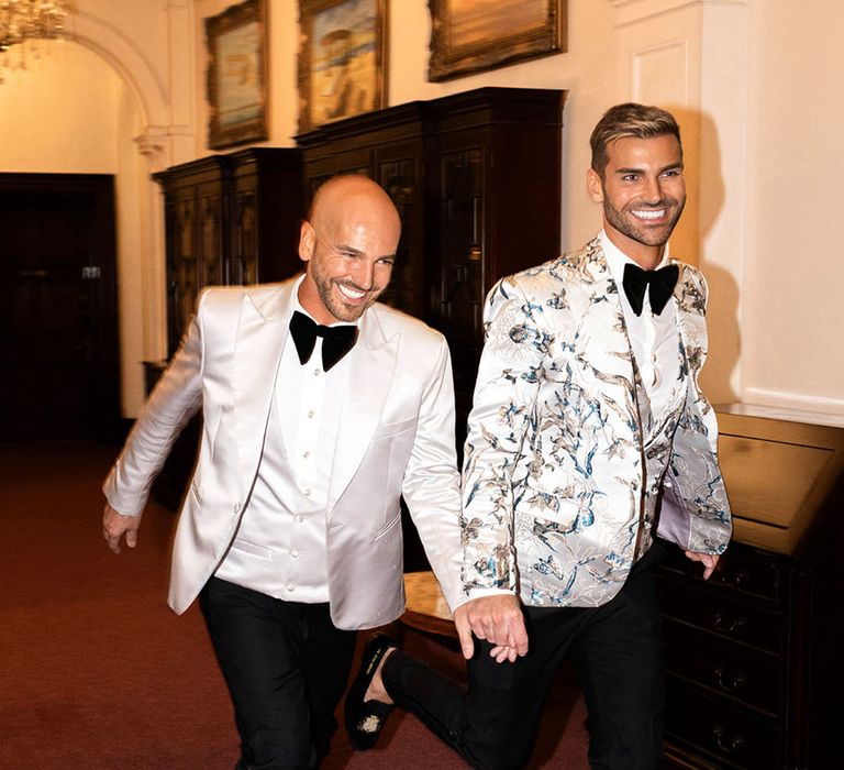 Grooms entering their wedding breakfast together in black tie wedding fashion 