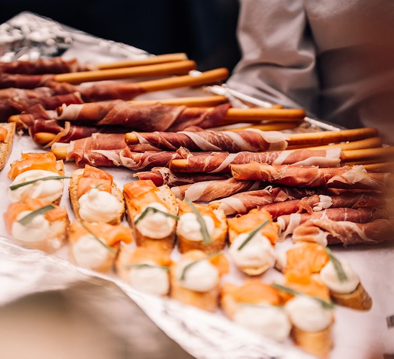 Canapes for wedding guests to enjoy with breadsticks and dried meats 