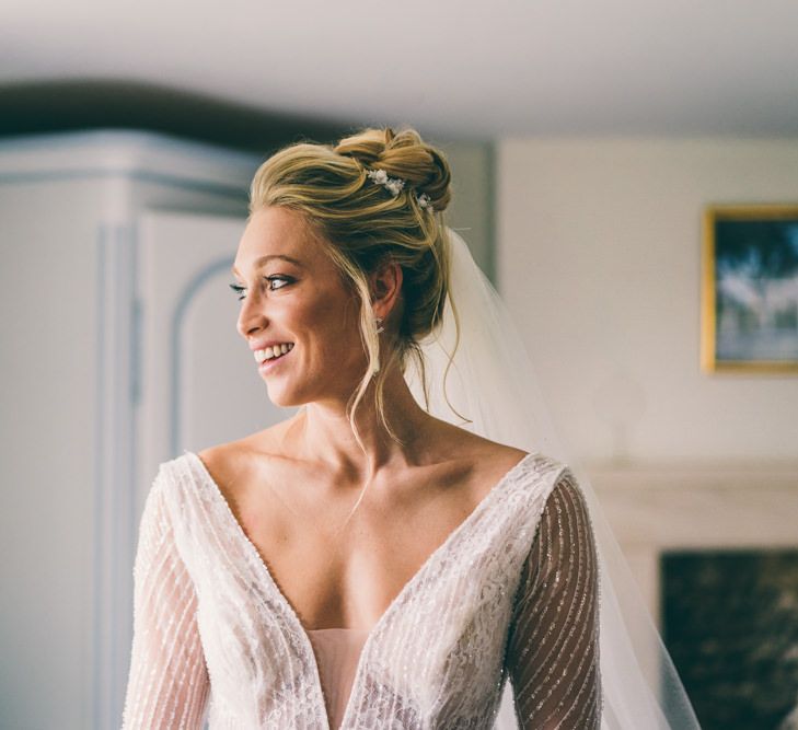 Beautiful bride with loose topknot wedding hair 