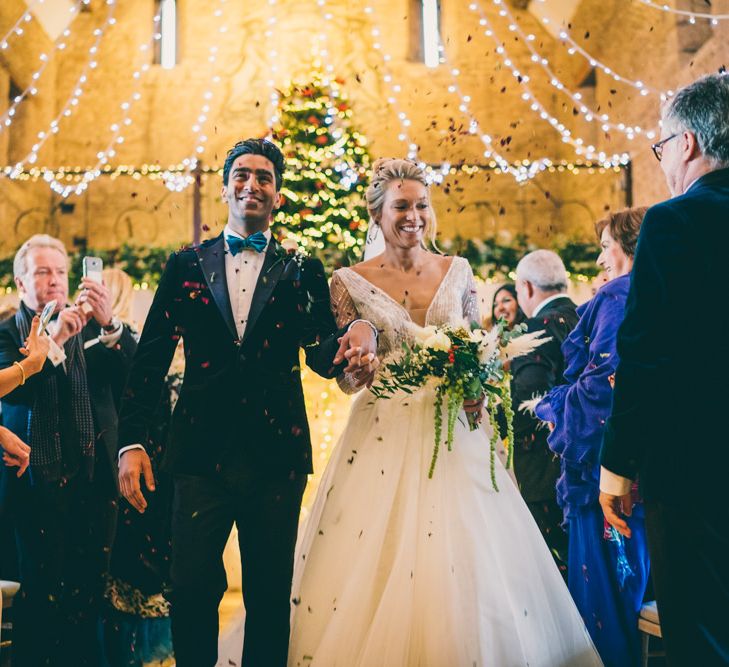 Bride and groom descending up the aisle as husband and wife 