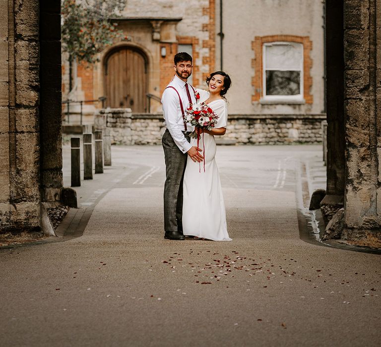 Bride and Groom standing under archway in Oxford