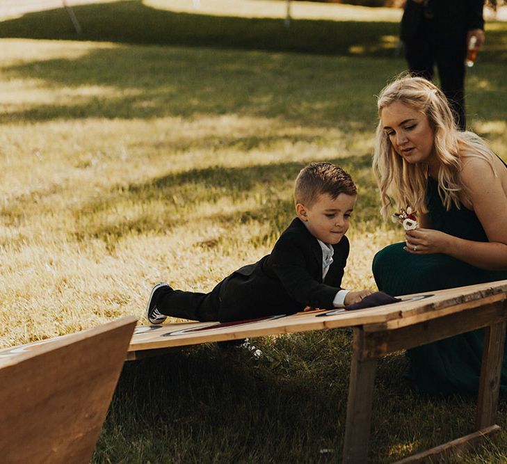 Bridesmaid plays with boy at wedding