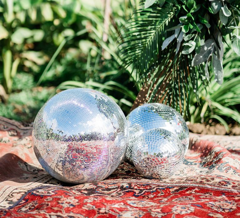 Two big mirror balls wedding decor on Persian rug