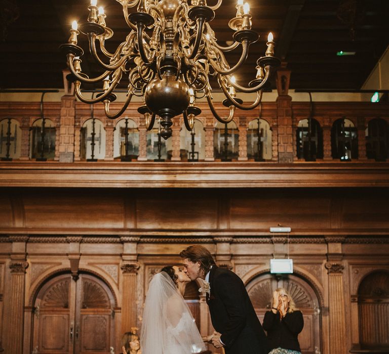 Bride and groom kissing at the altar at their Rhinefield House wedding 