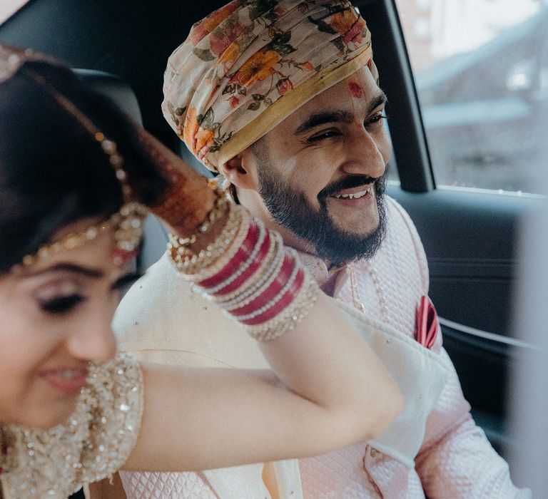 Bride & groom in the car on their wedding day 