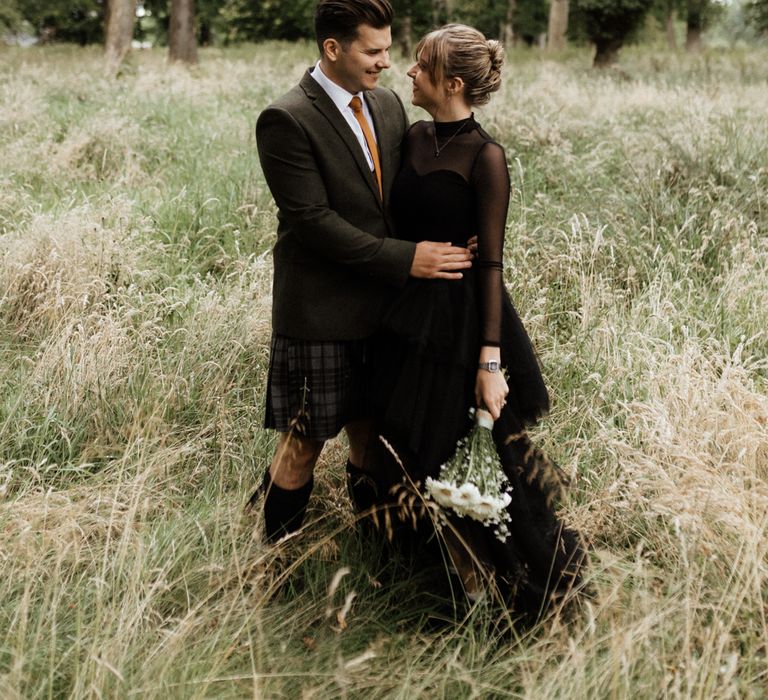 Bride & groom embrace during Scottish elopement