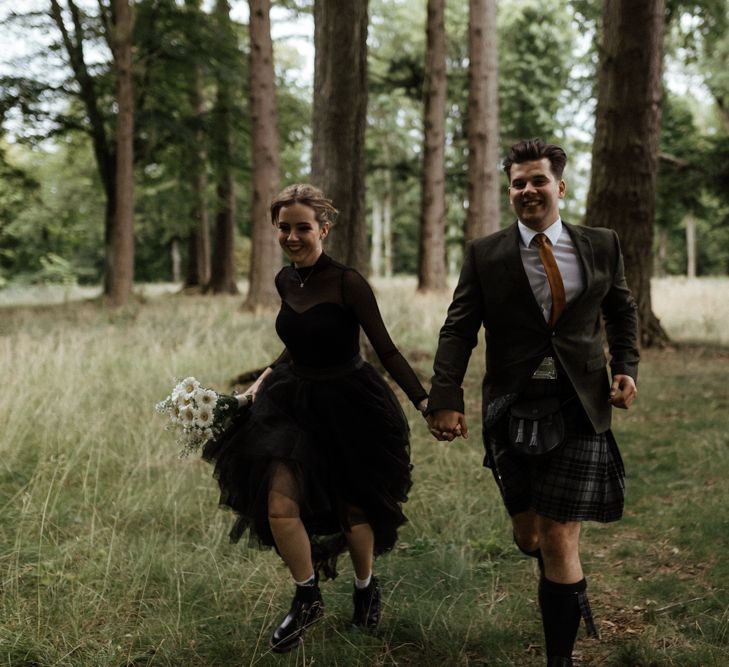 Bride & groom walk through fields wearing matching Dr. Martens