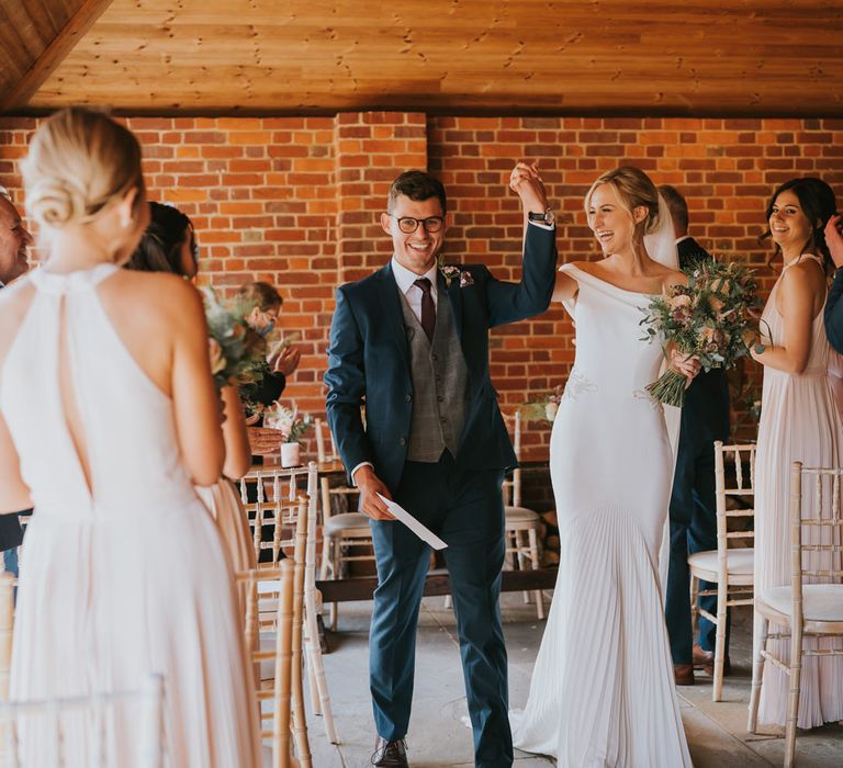 Bride & groom celebrate after marriage during wedding ceremony