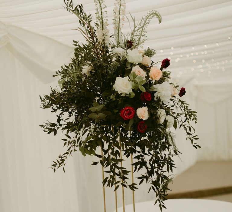 Pink, white and red rose and foliage floral decoration in marquee at Drenagh Estate wedding