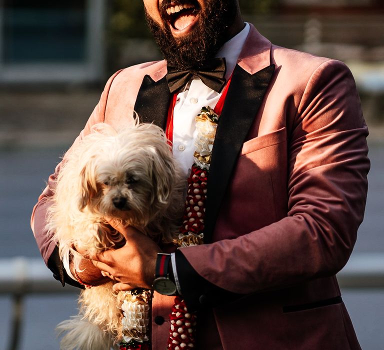 Groom wears pink Topman suit whilst holding dog