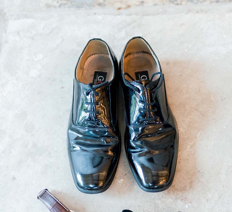 Shiny shoes, bow tie and watch grooms accessories 