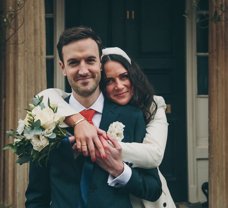 Bride and groom hugging outside bath wedding venue