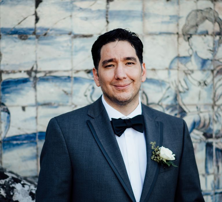 Groom wears black tie 