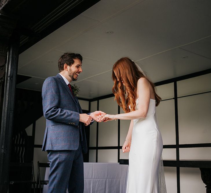 Intimate Larmer Tree wedding with groom in a navy suit and the bride in a satin slip Grace Loves Lace wedding dress